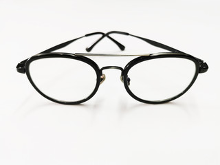 Black plastic eyeglasses frames with clear lens isolated on white background. Retro optical frame. Round vintage eye glasses frame.