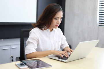Asian business women using notebook and  serious and headache for working