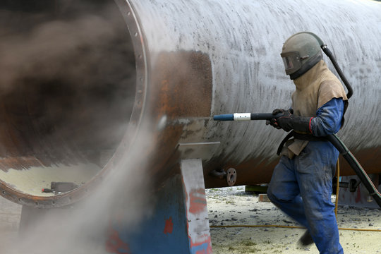 Engineer Sandblasting A Steel Casing