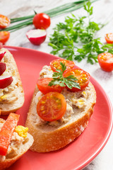 Closeup of sandwiches or baguette with mackerel or tuna fish paste on plate, healthy nutrition