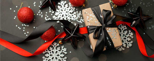 christmas or new year composition. christmas winter decoration, gift box on dark blackboard...