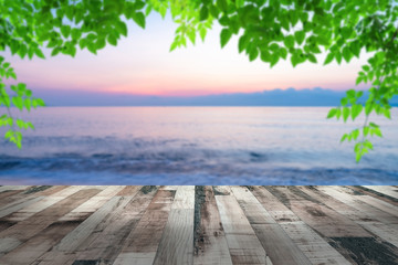 Fototapeta na wymiar summer sea with green leaves pattern at sunset and copy space,sky relaxing concept,beautiful tropical background for travel landscape