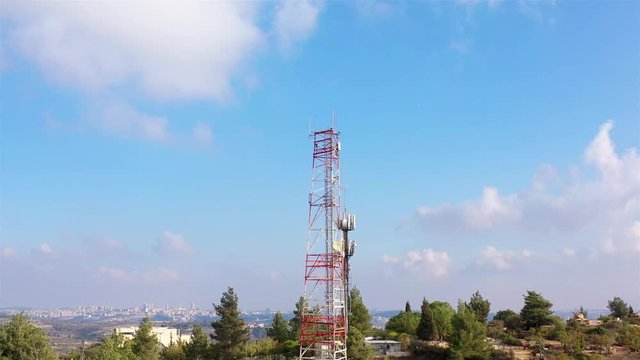 Aerial footage Close to Radio and cellular Antenna Drone view over Radio and cellular Antenna in small town with Mountains landscape