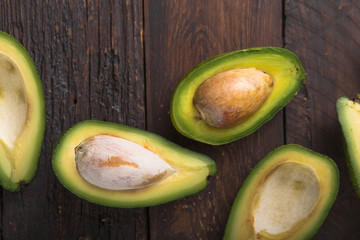 Fresh organic avocado halves on old wooden table background.Healthy food concept with copy space.
