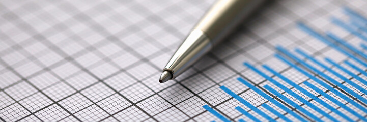 Silver pen lies on paper documents with color