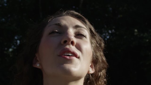 Millennial Young Woman Looking At A Drone In Super Slow Motion Closeup Wind Blowing Hair