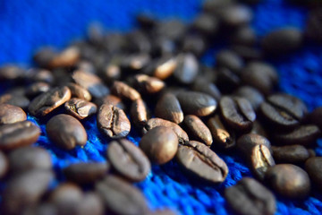 coffee beans on the blue background close-up