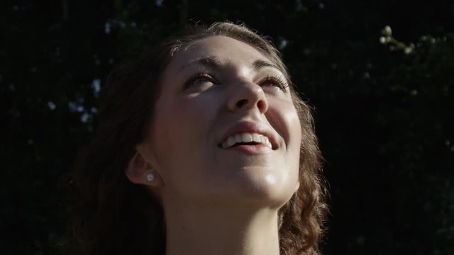 Millennial Young Woman Looking At A Drone In Super Slow Motion Closeup Wind Blowing Hair