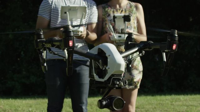 UAV Quadcopter Flying In Super Slow Motion With Two Hip Engineering Pilots In The Background