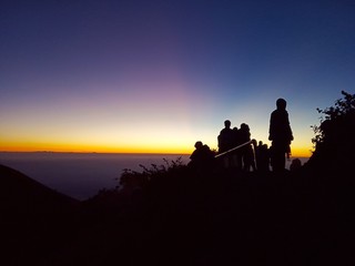 Fototapeta na wymiar silhouette of man on top of mountain