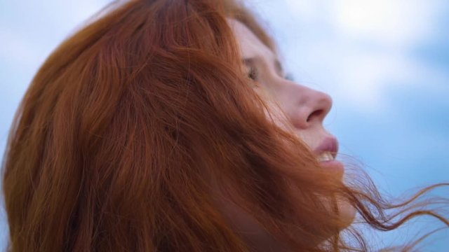 Сlose up Portrait of Beautiful Young Redhead Woman Exploring Spirituality Contemplating Future with Wind Blowing Hair