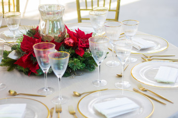Christmas table on a exterior yard, with gold setup.