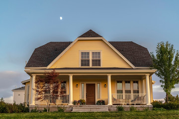 Traditional double storey timber clad yellow house