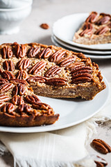 Pecan Pie on gray-brown background. Vegan dessert concept.