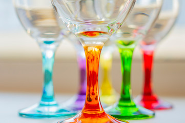  bright multi-colored glasses for wine and drinks. holiday texture. home holidays. home interior. kitchenware