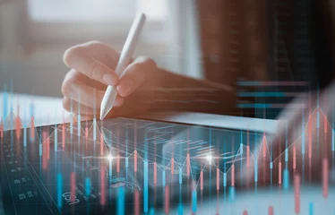 Foto op Plexiglas Stock exchange market concept, businessman trader looking on tablet with graphs analysis candle line in office room, diagrams on screen. © sitthiphong