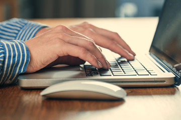 Woman working at home office hand on keyboard close up