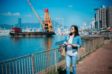 Girl traveling in Hong Kong Causeway Bay waterfront.