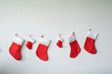 Christmas socks decoration toy hanging against wall for Christmas day on white wall background