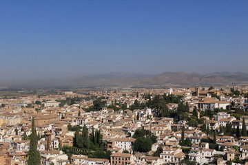 Fototapeta na wymiar Aerial view of the Albaicin city taken from Tower of the Cubo (Cube Tower) of the historical Alhambra Palace complex in Granada, Andalusia, Spain.