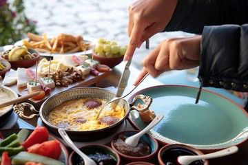 Mixed Omelette; delicious omelette cooked with sucuk, mushroom and served with mixed vegetables for slide dishes in white plate for an healthy breakfast.