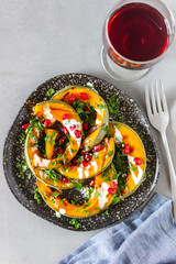 Grilled pumpkin with pomegranate and white sauce. Healthy eating.