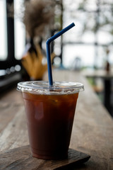 Iced coffee on a wooden table ,Iced coffee on a wooden table in the cafe atmosphere