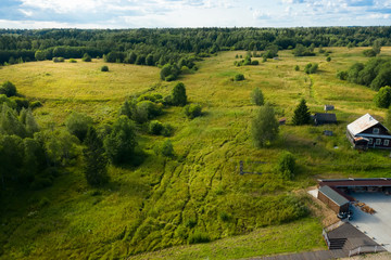 Obraz premium Aerial view from above on the forest and field in the countryside