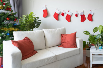 Empty living room is decorated with Christmas tree and gift presents for Christmas Day festival coming soon as background
