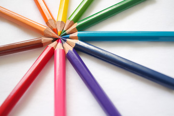 Fototapeta premium Colorful colored pencils close up, art supplies for painting education in classroom, kids stationary in school on white background, rainbow unicorn color, diversity,happy life, gay pride, lgbt concept