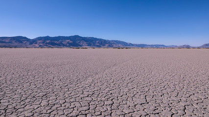 Panoramic view at Alvord desert with Steens mountains in the background. View of cracked Alvord Lake playa.