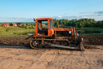 Fototapeta premium Caterpillar agricultural tractor DT-75 in the countryside