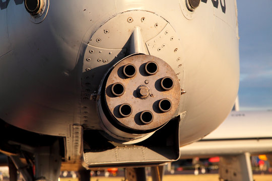 Up close photo of 7-barrel machine gun mounted on a plane