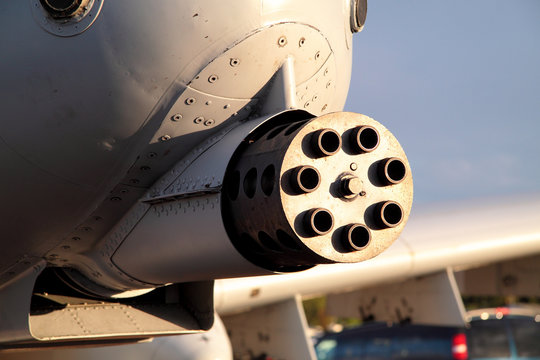 Up close photo of 7-barrel machine gun mounted on a plane