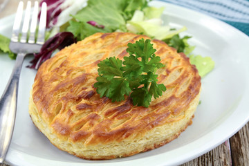 cheese puff pastry with salad on a plate