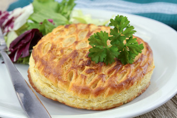 cheese puff pastry with salad on a plate