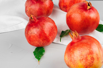 Ripe pomegranates on a light gray kitchen table