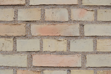 Yellow and orange bricks in a wall of an old building in Europe