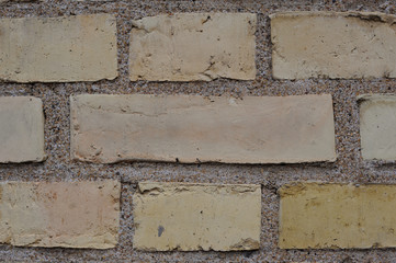 Yellow and orange bricks in a wall of an old building in Europe