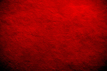 antique colored paper background texture with dark in old distressed vintage design. Colour of paper red, christmas texture