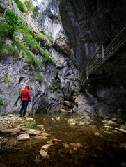 man is standing at a canyon in the baerenschuetzklamm in austria