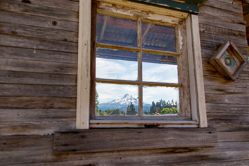 Looking through an old small wooden house window at Mt Hood, Oregon