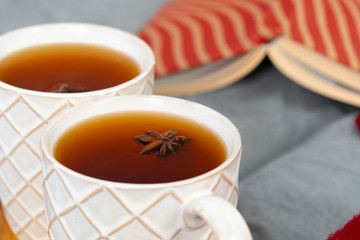 Close up shot of a cups of tea on wooden board at a Christmas interior