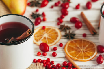 Autumn composition with hot mulled wine and spices on wooden background