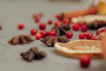 Berries and spices for mulled wine cooking close up on kitchen table
