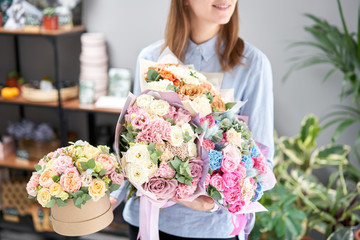 Beautiful bouquet of mixed flowers in woman hand. Floral shop concept . Handsome fresh bouquet. Flowers delivery. Red and pink color.