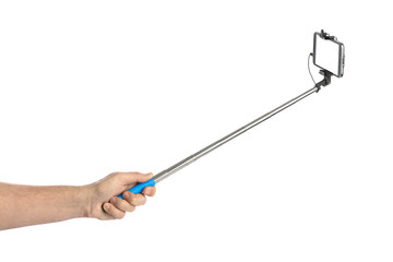 Hand and smartphone with selfie stick