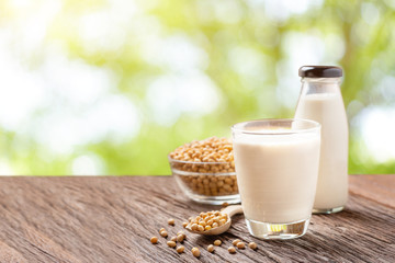 Homemade Soy milk and Soybean on wooden table, blur bokeh background with Copy space. Healthy drink.