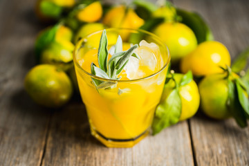 Sweet old-fashioned cocktail with orange and sage. Selective focus. Shallow depth of field.