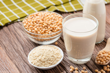 Homemade Soy milk and Soybean with Soy flour on wooden background, Healthy drink.
